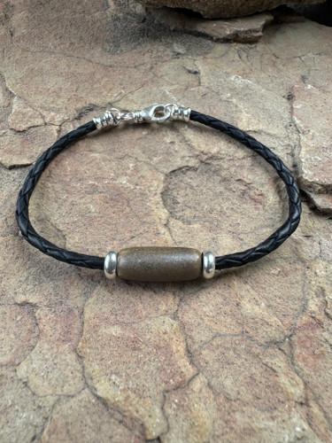 Hand made ceramic ash bead on a braided leather cord with a selrtling silver swivel clasp.  Color of this bead is Chocolate Brown.