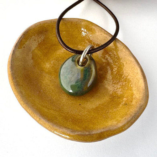 Green Sisu Beads Cremation Ash Necklace Phoenix Bead. Glaze is glossy and has lots of variation in the color. It is beautiful.