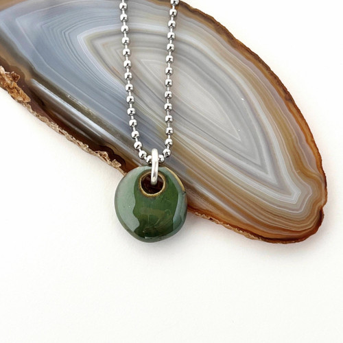 Green Phoenix bead cremation ash necklace.  Shown on a stainless steel ball chain.