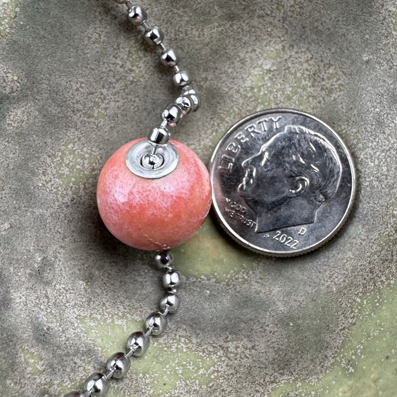 Shown in Pink, cremation ash bead by Sisu Beads. This is a glossy glaze.
