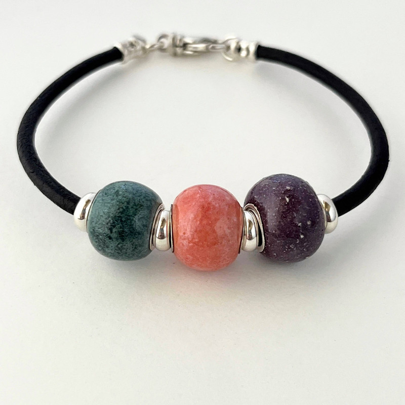 Cremation ash bracelet. This bracelet can be ordered with multiple beads. From left to right, Blue, Pink and Purple. 
