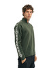 Dale of Norway - Geilo Men's 1/4 Zip Sweater: Dark Green/Off White, 95041-N_Model right side
Photo credits: Dale of Norway
medium high neck with raglan sleeves and ribbed knit construction. Norwegian eight-petal rose pattern along the sleeves.