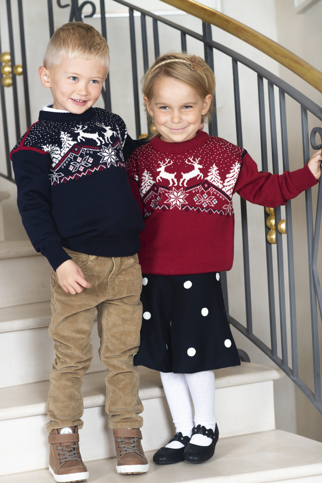Kids wearing Dale of Norway Dale Christmas sweaters in Red Rose, 93941-B and Navy, 93941-C