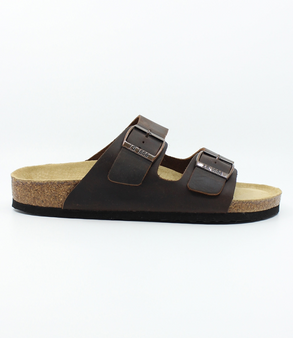Mens brown leather two strap sandal with adjustable buckles, contoured footbed and cork midsole.