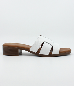 White women’s criss‑cross leather low‑heel slide sandal with cushioned footbed.
