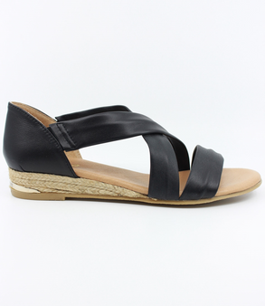 Black women’s leather low‑wedge sandal with crossover straps, enclosed heel and jute trim.