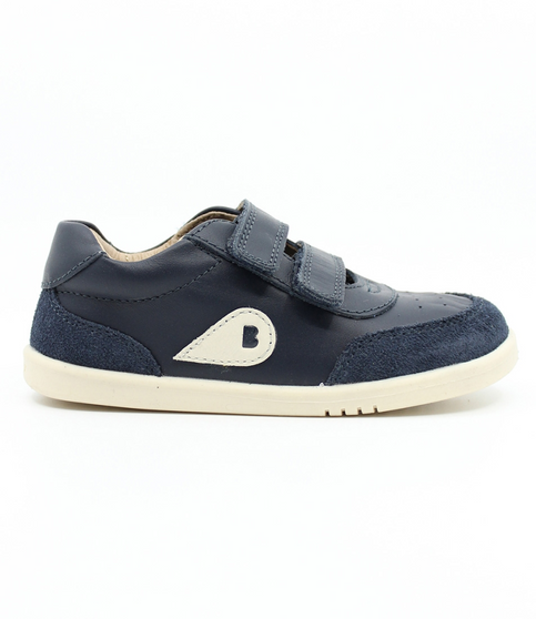 Side view of the Champ showing the navy leather upper, white sole and double straps.