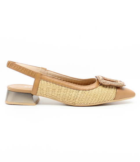 Side view showing the DALI tan slingback with woven raffia front, open back and low heel.