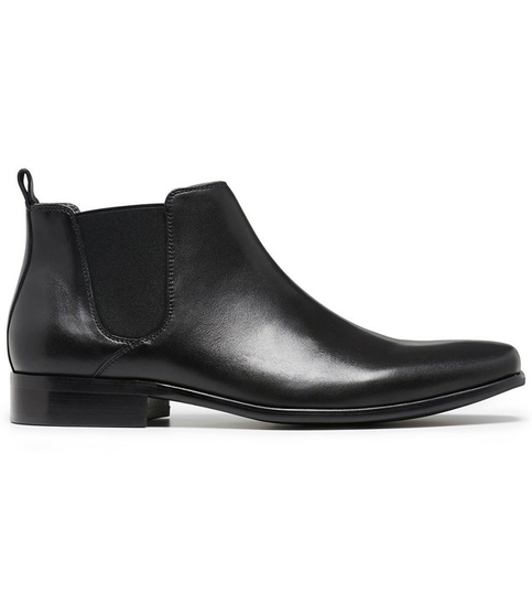 Side view of the KICK black Chelsea boot showing smooth upper and elastic gusset.