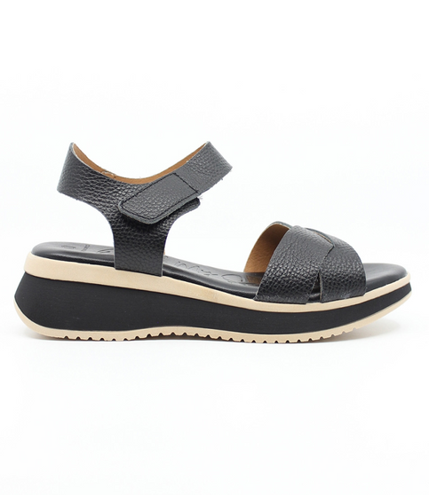 Black women’s criss‑cross leather platform sandal with hook‑and‑loop ankle strap and cushioned footbed.