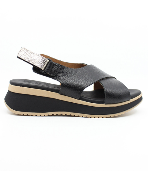 Black women's textured leather sandal with crossover straps, slingback strap and cushioned footbed.