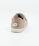 Back view of the Grass Court showing the rose‑gold leather upper, white sole and double straps.