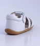 Cross Jump showing the white leather upper, cut‑outs and ankle strap.