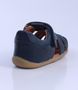 Roam showing the navy closed‑toe upper, side cut‑outs and ankle strap.