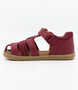 Roam showing the cherry leather upper, side cut‑outs and ankle strap.