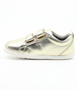 Grass Court showing the pale‑gold leather upper, white sole and double straps.