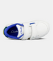 White kids sneaker with dual self‑fastening straps and flexible sole