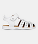 White leather girls’ sandal with caged‑toe design and flower cut‑outs
