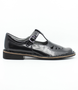 Black leather girls T‑bar school shoe with perforated vamp and buckle strap.
