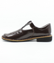 Brown leather girls T‑bar school shoe with perforated vamp and buckle strap.