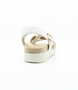 White Combo women’s synthetic crossover strap sandal with cushioned footbed and gold buckle ankle strap.