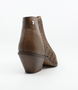 Cuero women’s woven leather ankle boot with pointed toe, side zip and stacked heel.