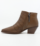 Cuero women’s woven leather ankle boot with pointed toe, side zip and stacked heel.