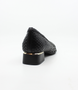 Negro women’s woven leather flat with pointed toe and metallic block heel.