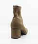 Taupe women’s stretch suede ankle boot with pointed toe and block heel.
