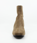 Taupe women’s stretch suede ankle boot with pointed toe and block heel.
