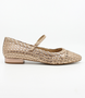 Nude women’s woven leather flat with pointed toe, adjustable strap and low block heel.