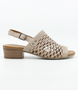 Beige women’s laser‑cut leather sandal with adjustable strap and low block heel.
