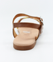 Tan girls’ woven leather flat sandal with ankle strap and cushioned footbed.