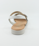 White girls’ woven leather flat sandal with ankle strap and cushioned footbed.