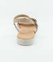 Nude girls’ woven leather flat sandal with ankle strap and cushioned footbed.