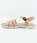 Nude girls’ woven leather flat sandal with ankle strap and cushioned footbed.