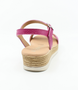 Fuchsia girls’ leather platform sandal with ankle strap and cushioned footbed.