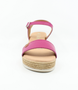 Fuchsia girls’ leather platform sandal with ankle strap and cushioned footbed.