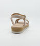 Nude girls’ woven leather flat sandal with ankle strap and cushioned footbed.