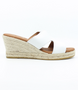 White women’s criss‑cross leather wedge slide sandal with cushioned footbed.
