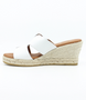 White women’s criss‑cross leather wedge slide sandal with cushioned footbed.
