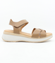 Taupe women’s criss‑cross leather platform sandal with hook‑and‑loop ankle strap and cushioned footbed.