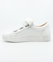 White women’s leather casual sneaker with oversized laces, side zip and cushioned removable insole.