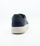 Navy women’s leather casual sneaker with oversized laces, side zip and cushioned footbed.