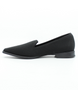 Black women’s perforated flyknit slip‑on flat with notched vamp and cushioned footbed.