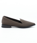 Chocolate women’s perforated flyknit slip‑on flat with notched vamp and cushioned footbed.