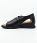 Black women’s leather closed‑heel sandal with side cut‑outs, lace‑up front and low wedge sole.