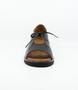 Black women’s leather closed‑heel sandal with side cut‑outs, lace‑up front and low wedge sole.