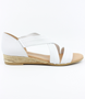 White women’s leather low‑wedge sandal with crossover straps, enclosed heel and jute trim.