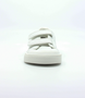 White kids' faux-leather barefoot trainer with hook-and-loop straps and reinforced toe cap.